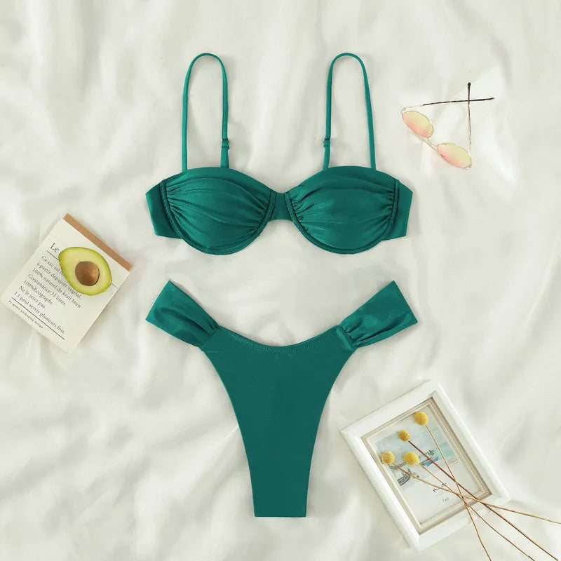 Laguna Minimalist Two Piece Bikini Set in a high-cut silhouette from 7th of April boutique set on a white surface with decorative items.