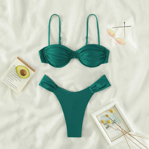 Laguna Minimalist Two Piece Bikini Set in a high-cut silhouette from 7th of April boutique set on a white surface with decorative items.