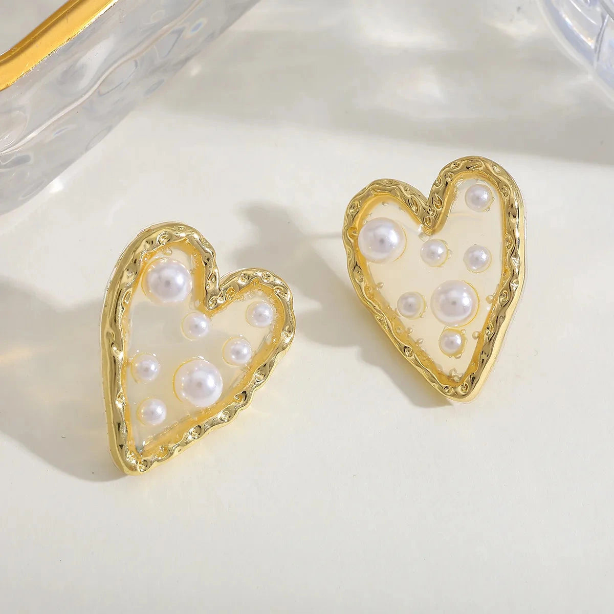 Waterproof Gold Corazon Islena Heart Earrings with pearls in 18K gold plated stainless steel on a light background