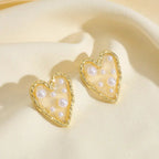 Waterproof Gold Corazon Islena Heart Earrings with pearls in 18K gold plated stainless steel on a beige background