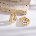 Waterproof Gold North Sea Hoop Earrings in 18K gold plated stainless steel on a light background