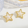 Waterproof Gold Perla Estrella Star Earrings in 18K gold plated stainless steel on a light background