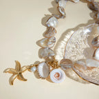 Waterproof Gold Starfish Charm Pendant Necklace in 18K gold plated stainless steel on a light background |7th of April